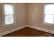 Simple bedroom featuring hardwood floors, natural light, and ample closet space for organized living at 4630 Roberta Rd, Concord, NC 28027
