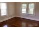 Cozy bedroom featuring hardwood floors and ample natural light from windows on two walls at 4630 Roberta Rd, Concord, NC 28027