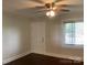 Neutral bedroom featuring a ceiling fan, hardwood floors, and a large window, providing natural light at 4630 Roberta Rd, Concord, NC 28027