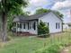 Exterior view of a charming home featuring light siding, black shutters, and a chain-link fence at 4630 Roberta Rd, Concord, NC 28027