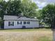 The charming single story home features neutral siding, a dark roof, and a spacious backyard at 4630 Roberta Rd, Concord, NC 28027