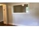 Neutral interior view with a cut-out window to another room and classic trimwork above baseboards at 4630 Roberta Rd, Concord, NC 28027