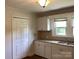 Kitchen features matching appliances, granite countertops, new white cabinets, and stainless-steel sink at 4630 Roberta Rd, Concord, NC 28027