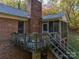 Brick home with a deck and stairs leading down to the yard at 480 S Ingleside Farm Rd, Iron Station, NC 28080