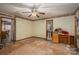 Spacious bedroom shows potential with natural light, ceiling fan, and open doorway at 480 S Ingleside Farm Rd, Iron Station, NC 28080