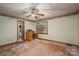 This is a bedroom with natural light streaming through the window onto the unfinished floors at 480 S Ingleside Farm Rd, Iron Station, NC 28080