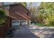 Three-car garage with a driveway and a staircase leading to the backyard at 480 S Ingleside Farm Rd, Iron Station, NC 28080