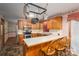 Efficient kitchen with oak cabinets, stainless appliances, and a breakfast bar, perfect for quick meals and conversation at 480 S Ingleside Farm Rd, Iron Station, NC 28080