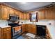 Functional kitchen featuring oak cabinets, stainless steel appliances, and durable countertops, ready for cooking at 480 S Ingleside Farm Rd, Iron Station, NC 28080
