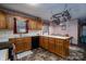 Practical kitchen with oak cabinetry, solid countertops, and easy access to dining area, great for Gathering meals at 480 S Ingleside Farm Rd, Iron Station, NC 28080