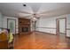 Bright living room featuring hardwood floors, a brick fireplace, and neutral walls, ready for personalization at 480 S Ingleside Farm Rd, Iron Station, NC 28080