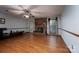 Open living room with hardwood floors, a brick fireplace, and plenty of natural light, perfect for entertaining at 480 S Ingleside Farm Rd, Iron Station, NC 28080