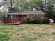 Charming single-story brick home with a cozy front porch and blossoming landscaping at 4817 Ridgeley Dr, Charlotte, NC 28208