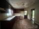 Functional kitchen with tile flooring, ample cabinet space, and a convenient back door at 4817 Ridgeley Dr, Charlotte, NC 28208