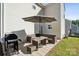 Back patio features outdoor seating, table, umbrella, grill, and backyard at 509 Ellingsworth Ln, Charlotte, NC 28214