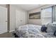 Comfortable bedroom features light walls, patterned bedding, closet, and bright window at 509 Ellingsworth Ln, Charlotte, NC 28214