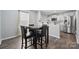Dining area with a counter overlooking the kitchen and a table with chairs, great for dining or entertaining at 509 Ellingsworth Ln, Charlotte, NC 28214