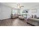 Bright living room with hardwood floors, large window, and cozy seating arrangement, creating a relaxing atmosphere at 509 Ellingsworth Ln, Charlotte, NC 28214