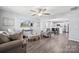 Inviting living room with hardwood floors, a ceiling fan, and comfortable seating next to an open kitchen at 509 Ellingsworth Ln, Charlotte, NC 28214