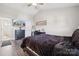 Bright main bedroom with ceiling fan, dark wood furniture, and plush bedding at 509 Ellingsworth Ln, Charlotte, NC 28214