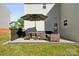 Back patio with patio furniture, grill, green grass, and back of house at 509 Ellingsworth Ln, Charlotte, NC 28214