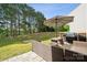 Back patio with outdoor furniture, including seating, table, umbrella, and grill at 509 Ellingsworth Ln, Charlotte, NC 28214