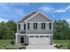 Charming two-story home with gray siding, white trim, and an attached two-car garage at 5216 Mccallum Meadows Dr, Charlotte, NC 28216