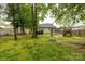 A spacious backyard is equipped with play equipment, a fire pit and backs to a home featuring a covered patio at 522 Kittiewake Ln, Clover, SC 29710