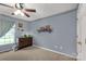 Well-lit bedroom featuring carpeted floors, wall decor, and a ceiling fan, making it a cheerful space at 522 Kittiewake Ln, Clover, SC 29710