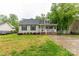 Charming single-story home featuring a welcoming front porch, well-maintained lawn, and mature trees at 522 Kittiewake Ln, Clover, SC 29710