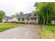 Inviting single-story home with a cozy front porch, long driveway, and lush green lawn at 522 Kittiewake Ln, Clover, SC 29710