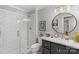 Modern bathroom featuring a glass-enclosed shower, granite vanity and round mirror at 530 Bonita Dr, Landis, NC 28088