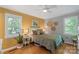 Inviting bedroom features hardwood floors, two sunny windows and a cozy queen-size bed at 530 Bonita Dr, Landis, NC 28088
