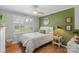 Serene bedroom with hardwood floors, white trim, and a cozy full-sized bed at 530 Bonita Dr, Landis, NC 28088
