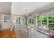 Sunlit dining area with large windows, a wooden table, and deck access at 530 Bonita Dr, Landis, NC 28088