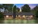 Charming brick home with well-maintained lawn, classic architecture, and mature trees under the colorful hues of dusk at 530 Bonita Dr, Landis, NC 28088