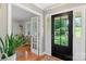 Welcoming foyer with hardwood floors, black front door with glass panes, and adjacent living area visible through glass doors at 530 Bonita Dr, Landis, NC 28088