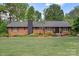 Brick home featuring a well-kept lawn, landscape and mature trees at 530 Bonita Dr, Landis, NC 28088