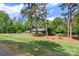Charming brick home with a well-manicured lawn and mature trees in a wooded lot at 530 Bonita Dr, Landis, NC 28088