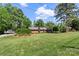 Well-maintained brick home with a lush green lawn and mature trees at 530 Bonita Dr, Landis, NC 28088