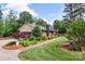 Charming brick home with a well-manicured lawn, landscape and mature trees at 530 Bonita Dr, Landis, NC 28088