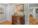 Charming hallway featuring hardwood floors, decorative furnishings, and neutral-toned walls with white doors at 530 Bonita Dr, Landis, NC 28088