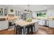 Spacious white kitchen featuring a large central island with bar seating, pendant lighting, and modern appliances at 530 Bonita Dr, Landis, NC 28088