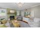 Cozy living room featuring a decorative fireplace, chandelier and soft, comfortable furnishings at 530 Bonita Dr, Landis, NC 28088