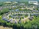 Aerial view of a residential area featuring a community amenity center by a pond and a single-Gathering home location at 5420 Meadowcroft Way, Fort Mill, SC 29708
