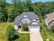 Aerial view of a home with a well-maintained lawn and mature trees at 5420 Meadowcroft Way, Fort Mill, SC 29708