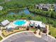 Aerial view of the amenity center with a pool, playground, and pond surrounded by trees, offering leisure in nature at 5420 Meadowcroft Way, Fort Mill, SC 29708