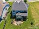 Aerial view highlighting a spacious backyard with a patio, seating area, and lush greenery, ideal for outdoor living at 5420 Meadowcroft Way, Fort Mill, SC 29708