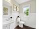 Bathroom with a pedestal sink, framed art, wainscoting, and a window allowing lots of natural light at 5420 Meadowcroft Way, Fort Mill, SC 29708