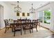 Formal dining room with wainscoting, large windows, and designer chandeliers at 5420 Meadowcroft Way, Fort Mill, SC 29708